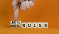 Legal or moral rules symbol. Businessman turns wooden cubes and changes words `legal rules` to `moral rules` on a beautiful or