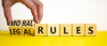 Legal or moral rules symbol. Businessman turns wooden cubes and changes words `legal rules` to `moral rules` on a beautiful wh