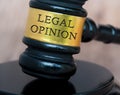 Legal opinion text engraved on lawyer gavel with blurred wooden background. Legal and law concept