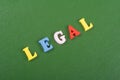 LEGAL word on green background composed from colorful abc alphabet block wooden letters, copy space for ad text. Learning english