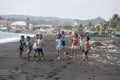 Poor but healthy children group portrait on the beach with volcanic sand near Mayon volcano in Legazpi, Philippines