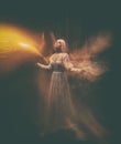 The legend of the Banshee fairy. Pale girl blonde, like a ghost, in a white vintage dress, flies, hovers in space. girl Royalty Free Stock Photo