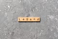 Legend word written on wood block. legend text on cement table for your desing, concept