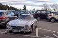 Legendary Gullwing Mercedes 300 SL sportcars to a road parking