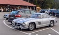 Legendary Gullwing Mercedes 300 SL sportcars to a road parking