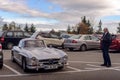 Legendary Gullwing Mercedes 300 SL sportcars to a road parking