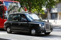 Legendary London taxi cab and red bus on the streets of London Royalty Free Stock Photo