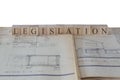 Legislation written on wooden blocks on house extension building plans blueprints Royalty Free Stock Photo