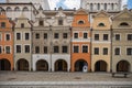 Facades of old tenement houses with beautiful renovated arcades in front of