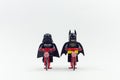 lego batman and darth vader riding bicycle together