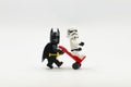 Lego batman pushing a trolley with lego storm trooper on it