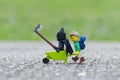 Lego batman sitting on wheelbarrow taking photo with lego hiker minifigures