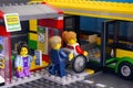 Lego Bus Station with bus and passenger - man helps woman in wheelchair, girl with smartphone