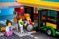Lego Bus Station with bus and passenger - woman helping woman in wheelchair and girl with smartphone