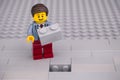 Lego businessman with brick ready to fill a hole