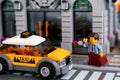 Lego businessman flagging down taxi on the street