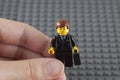 Lego businessman in human hand Royalty Free Stock Photo