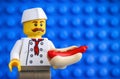 Lego chef with hot dog against blue baseplate backgrounds