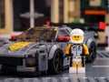 Lego Chevrolet Corvette C8.R race car driver minifigure by LEGO Speed Champions standing near his car
