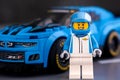 Lego Chevrolet driver near Lego Chevrolet Camaro ZL1 race car by LEGO Speed Champions