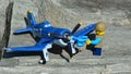 LEGO City boy figure adding oil to the propeller of Skipper plane model from Disney Pixar animated movie Planes