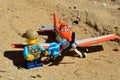 LEGO City figure of boy adding oil to propeller of die cast Mattel model of Dusty Crophopper airplane