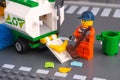 Lego cleaner with brush cleaning street and putting garbage in sweeper truck Royalty Free Stock Photo