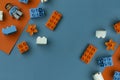 Lego constructor lies on an orange-blue background top view photo with empty space