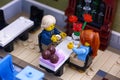 Lego couple in Restaurant. Man gets ready to propose with the ring