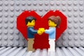 Lego couple standing in front of heart