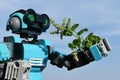 LEGO Creator robot examining closely fresh tip of Mint plant, possibly Mentha Spicata