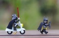 lego darth vader chasing batman using scooter.