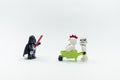lego darth vader giving order to storm trooper pushing wheelbarrow with lego chicken suit guy sitting on it