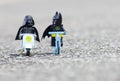 Lego darth vader riding scooter along with batman riding bicycle