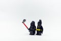 Lego darth vader taking photo with lego batman minifigures. Royalty Free Stock Photo