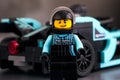 Lego driver minifigure against Formula E Panasonic Jaguar Racing Gen2 car by LEGO Speed Champions