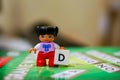 Lego Duplo girl figure with letter D brick