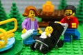 Lego family on a picnic in park with playground Royalty Free Stock Photo