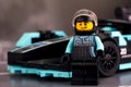Lego Formula E Panasonic Jaguar Racing Gen2 driver minifigure by LEGO Speed Champions near his car