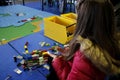 LEGO Fun Fest. Lego block fair. Girl building a house with Lego. Fun with games Royalty Free Stock Photo