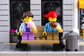 Lego girl and boy with ice creams seating on the bench