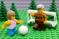 Lego girl playing soccer with her grandfather