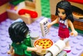 Lego girl with recipe and boy cooking pizza in Pizzeria kitchen