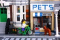 Lego girl riding bicycle along the street Royalty Free Stock Photo