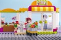 Lego girl with trolley of food came out from supermarket