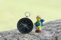 lego hiker with compass, soft background. This minifigure is from Collectable series 16 Royalty Free Stock Photo