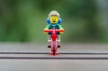 Lego hiker riding bicycle.