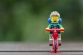 Lego hiker riding bicycle.