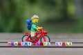 Lego hiker riding bicycle with word healthy lifestyle