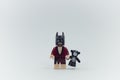 Lego lobster batman holding teddy bear.